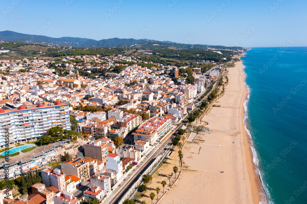 Fototapeta premium Aerial photo of Spanish municipality Canet de Mar with view of beach and residential buildings.