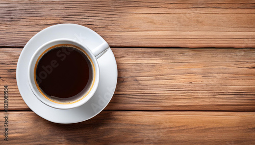 Cup of coffee on a wood table background. Top view with copy space