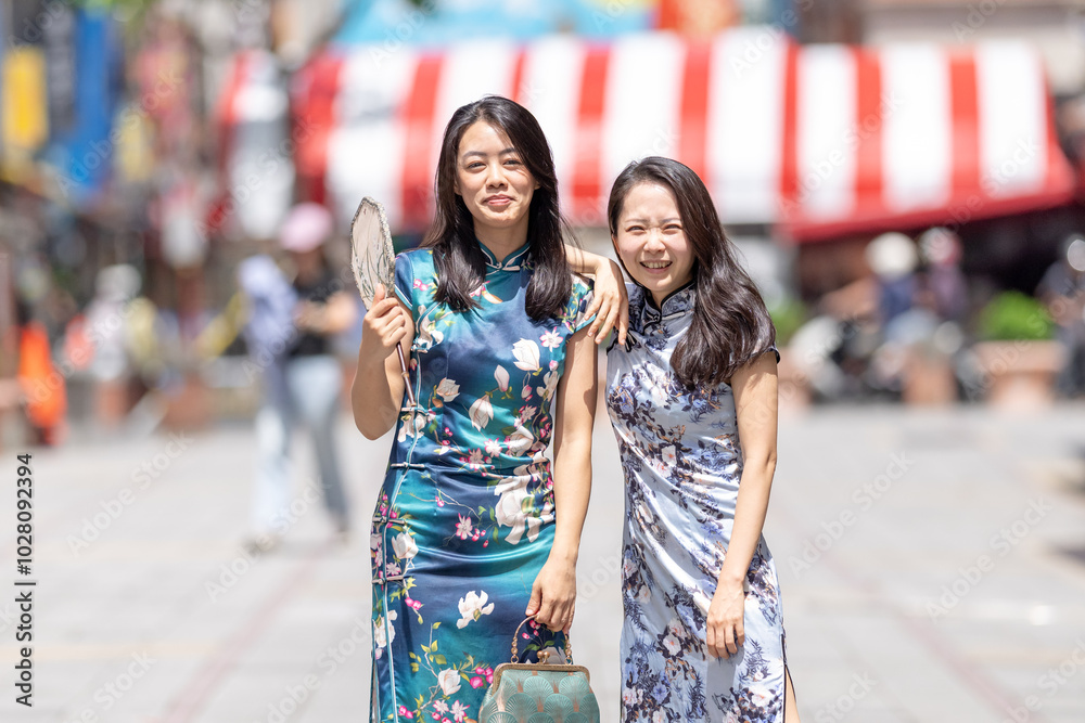 Two Taiwanese women in their 30s wearing traditional Chinese clothing are enjoying their time on Dihua Street in Taipei City, Taiwan, in September. Two Taiwanese women in their 30s wearing traditional Chinese clothing are enjoying their time on Dihua Street in Taipei City, Taiwan, in September.
