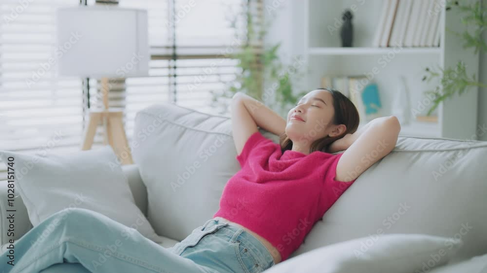 Relaxed young Asian woman enjoying rest on comfortable sofa, calm attractive girl relaxing on couch, breathing fresh air with eyes closed, meditating at home Relaxed young Asian woman enjoying rest on comfortable sofa, calm attractive girl relaxing on couch, breathing fresh air with eyes closed, meditating at home