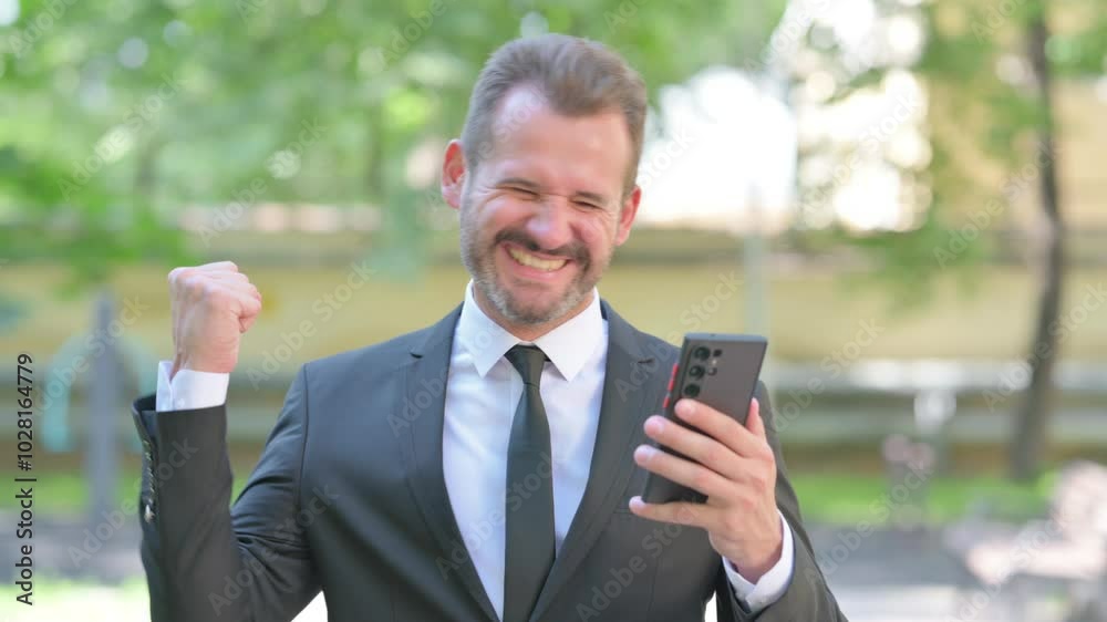 Portrait of Middle Aged Businessman Excited for Results on Phone Outdoor Portrait of Middle Aged Businessman Excited for Results on Phone Outdoor