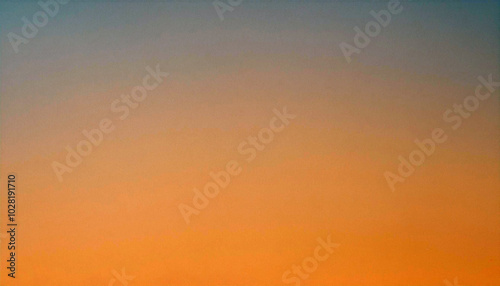 Serene Sunset: A captivating gradient of orange hues paints the sky, evoking tranquility and warmth. A peaceful moment captured.