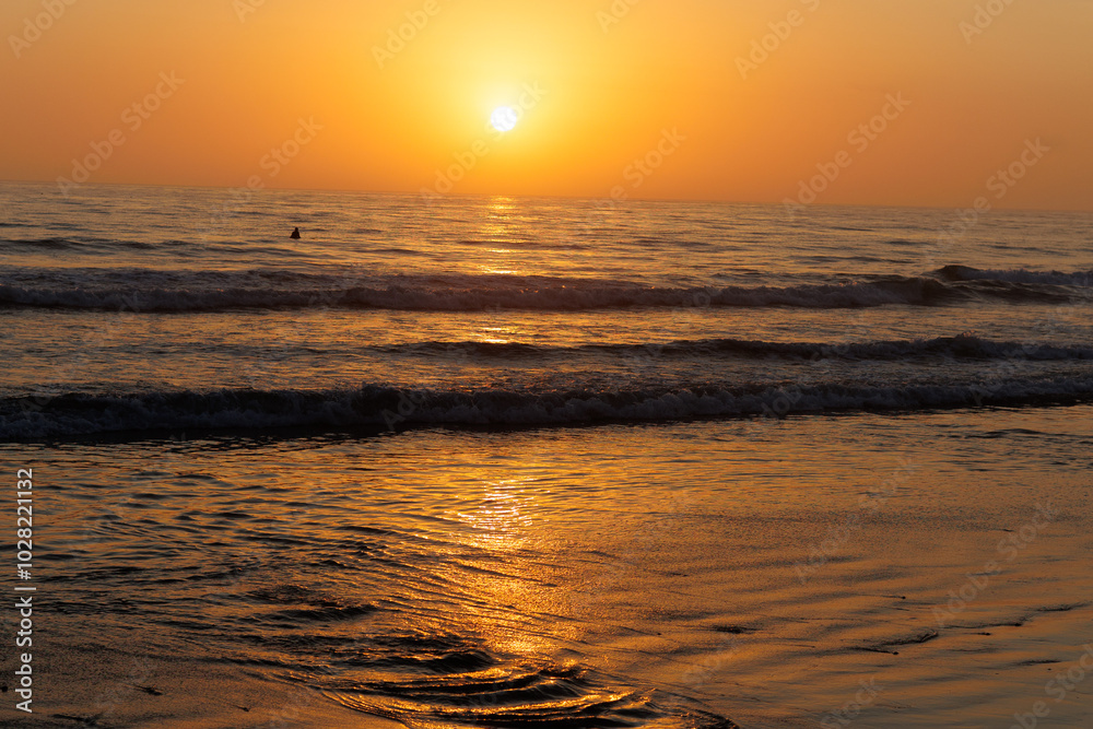Vibrant Orange and Red Sunset Reflecting Over the Ocean Vibrant Orange and Red Sunset Reflecting Over the Ocean