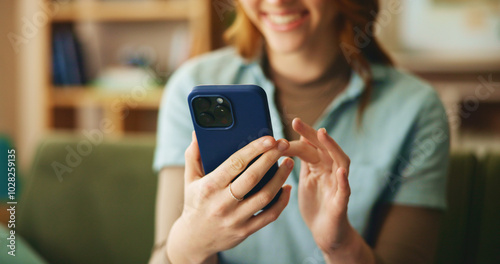 Hands, woman and smile with phone at house for loan approval, communication and bank application. Happy, girl and reading with mobile for social media, connection and investment update of mortgage photo