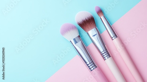 A set of makeup brushes on a light pink and blue background.