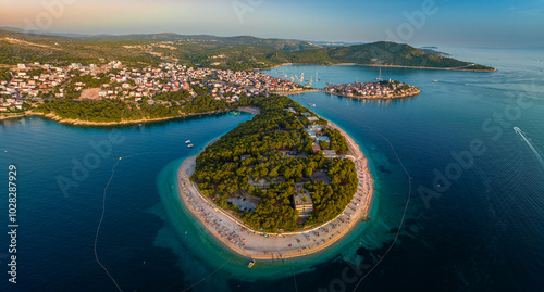 Primosten, Croatia - Aerial panoramic view of Primosten peninsula, beaches and old town on a sunny summer morning in Dalmatia, Croatia. Public beach and turquoise sea water at sunrise 