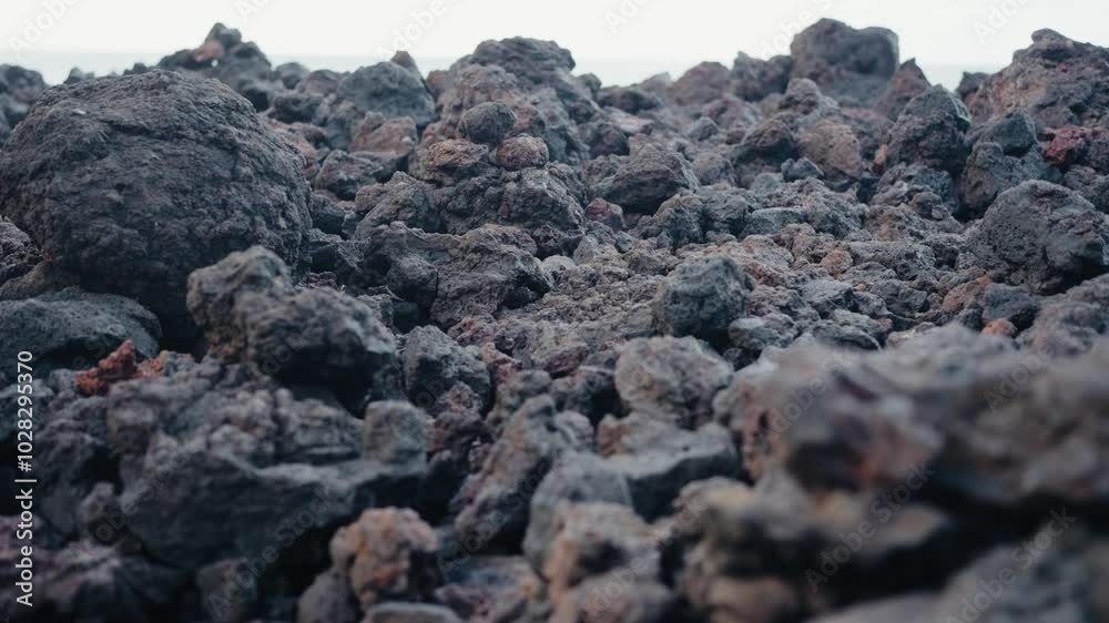 Detailed close-up photo of rough, textured volcanic rocks, capturing the rugged, natural landscape. Close-Up Of Rough Textured Volcanic Rocks. volcanic stones on ground Detailed close-up photo of rough, textured volcanic rocks, capturing the rugged, natural landscape. Close-Up Of Rough Textured Volcanic Rocks. volcanic stones on ground