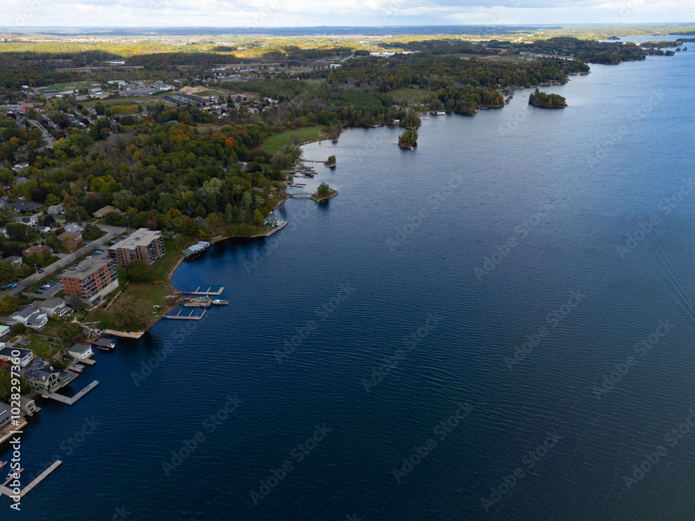 Tranquil aerial view of the 1000 Islands region, showcasing scattered islands on serene waters under a vast sky, capturing natural beauty and peacefulness. Tranquil aerial view of the 1000 Islands region, showcasing scattered islands on serene waters under a vast sky, capturing natural beauty and peacefulness.