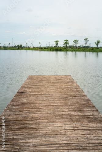 Wallpaper Mural A wooden footbridge or boat dock over the water lake with tranquil view. Outdoor and nature view photo scene. Torontodigital.ca