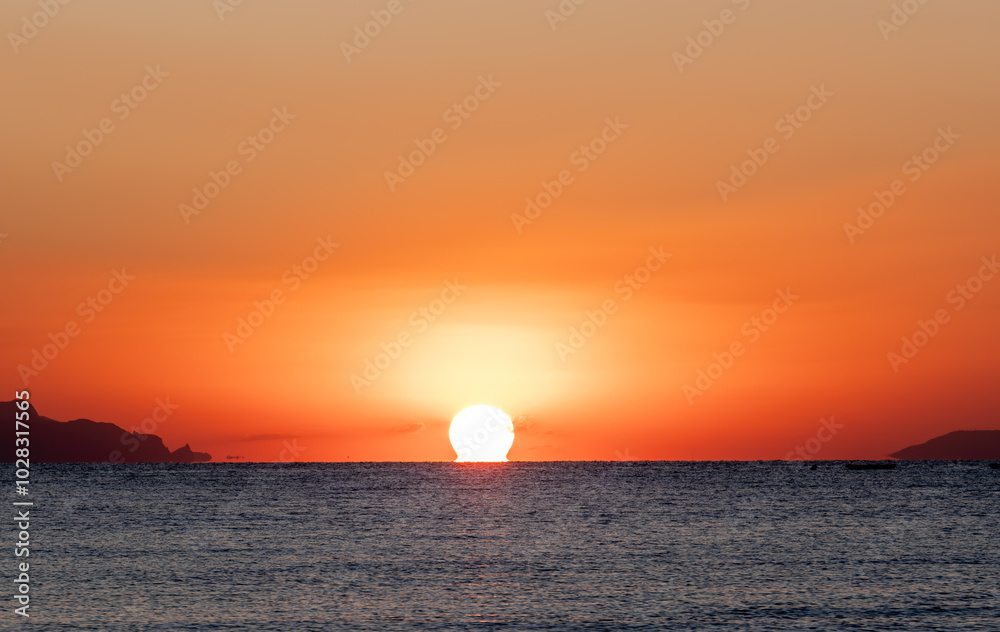 Sunrise over the sea in the early morning. The moment of separation of the sun from the water. Sunrise over the sea in the early morning. The moment of separation of the sun from the water.