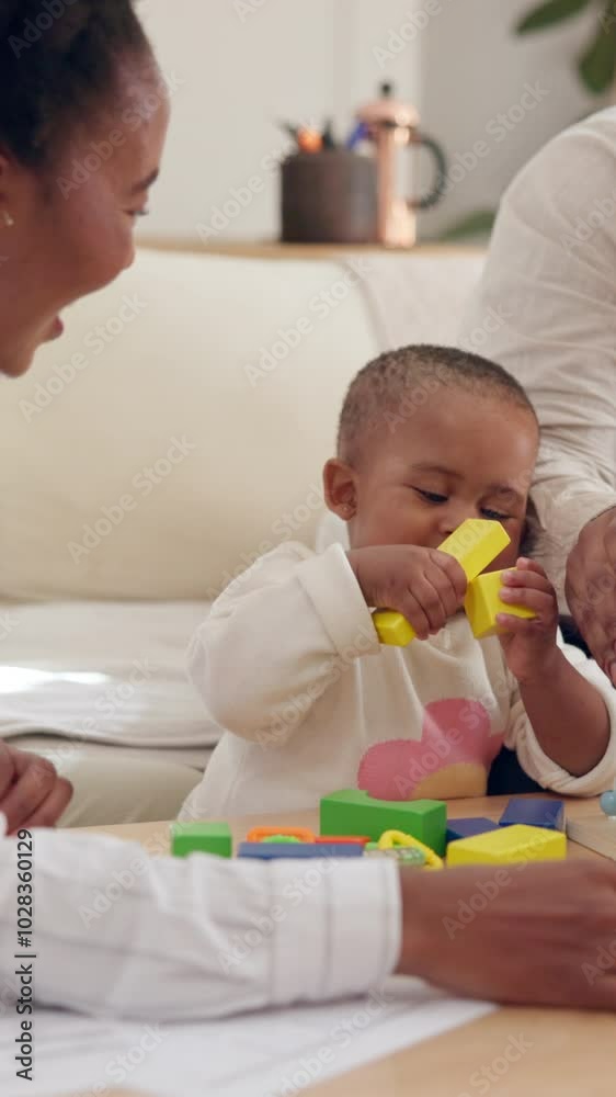 Toy, blocks and parents with toddler in home for education activity, growth and support in development. Family, father and mother playing with child at table for building, cognitive and motor skills Toy, blocks and parents with toddler in home for education activity, growth and support in development. Family, father and mother playing with child at table for building, cognitive and motor skills