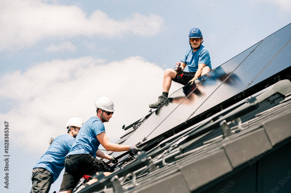 Engineers installing solar panels under cloudy sky Engineers installing solar panels under cloudy sky