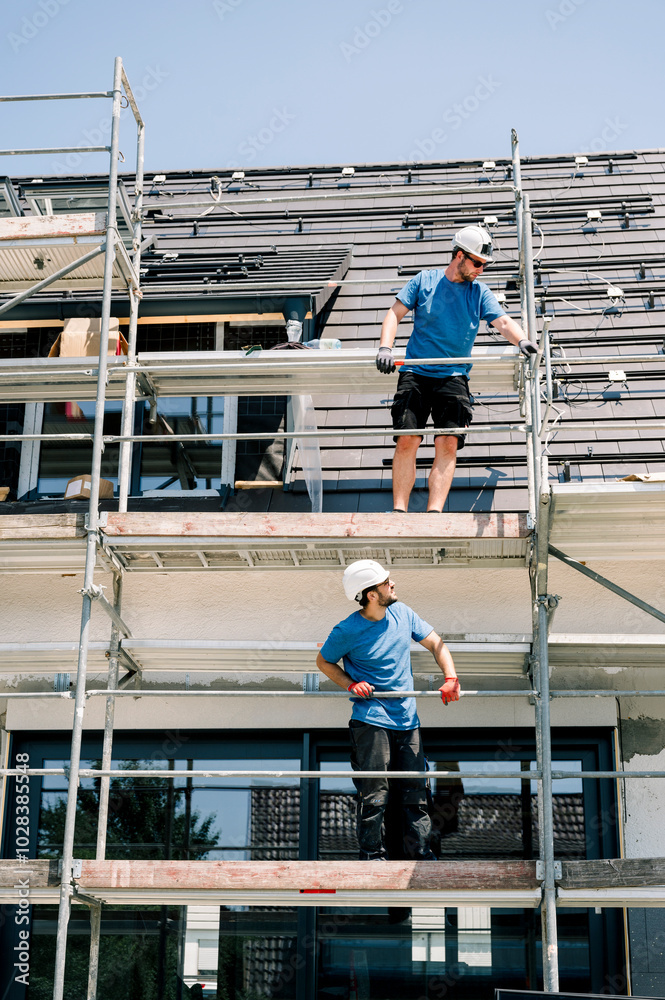 Engineers standing on scaffolding at construction site Engineers standing on scaffolding at construction site