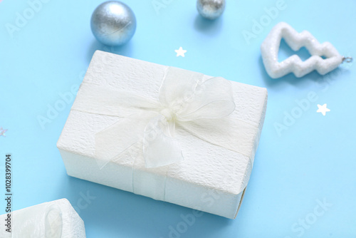 Christmas balls and gift box on blue background