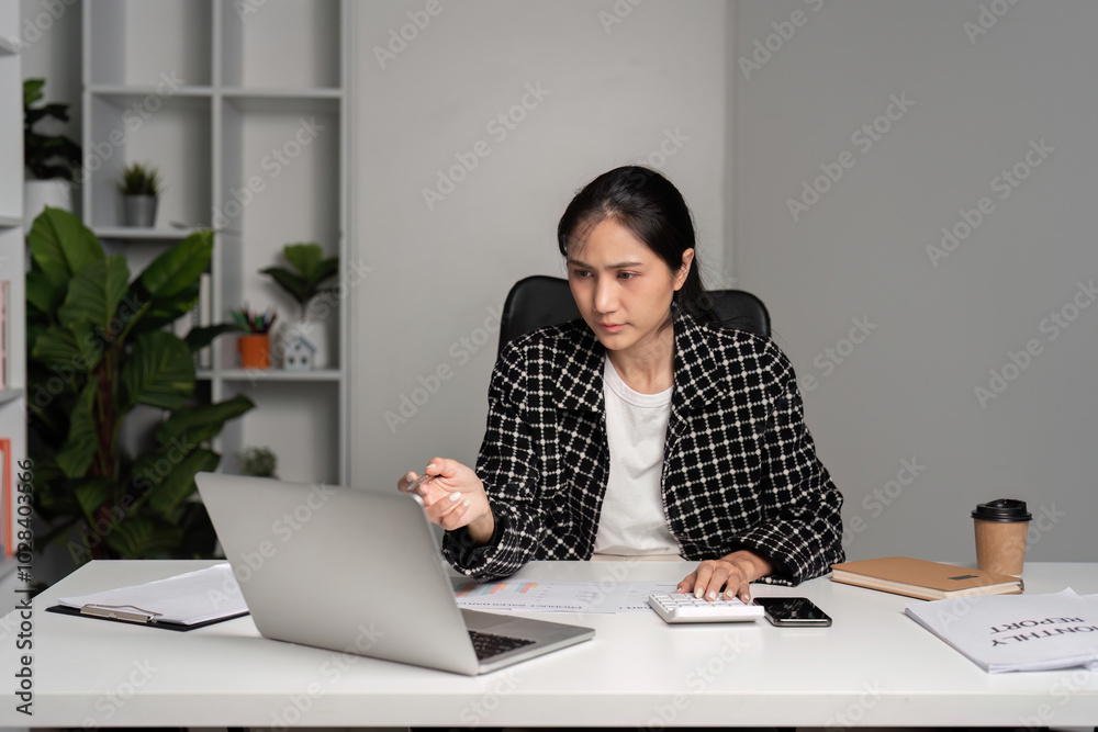 Stressed Businesswoman Facing Challenges at Work in Modern Office Setting with Laptop and Documents Stressed Businesswoman Facing Challenges at Work in Modern Office Setting with Laptop and Documents
