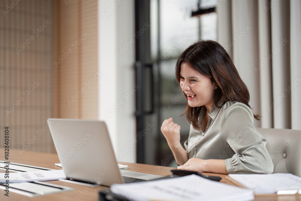 Happy Business Woman Celebrates Success at Work with Fist Pump in Modern Office Environment Happy Business Woman Celebrates Success at Work with Fist Pump in Modern Office Environment