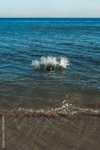 A woman falls into the water with splashes. photo