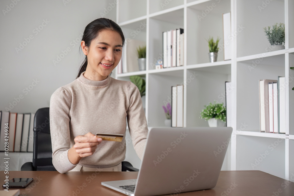 Woman Shopping Online Using Credit Card at Home Office Desk with Laptop and Modern Bookshelf Background Woman Shopping Online Using Credit Card at Home Office Desk with Laptop and Modern Bookshelf Background