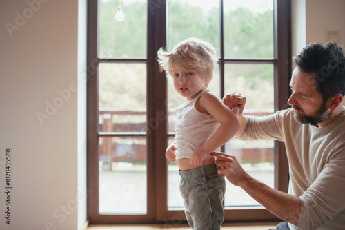 Father is checking his son's skin, looking for rashes or skin reactions. photo