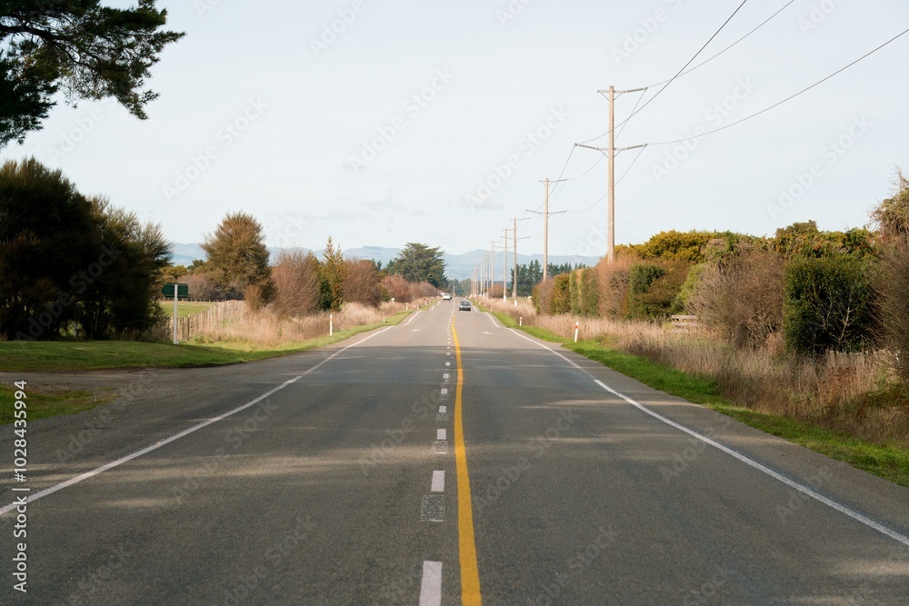 Sunny Day on New Zealand Highway - Scenic Road Through Countryside Sunny Day on New Zealand Highway - Scenic Road Through Countryside