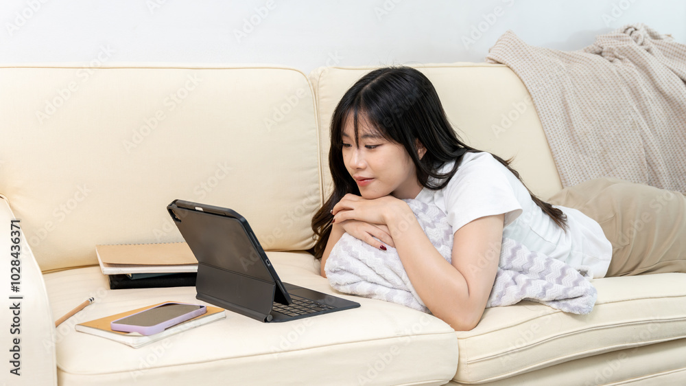 Young Asian woman having online meeting on tablet Young Asian woman having online meeting on tablet
