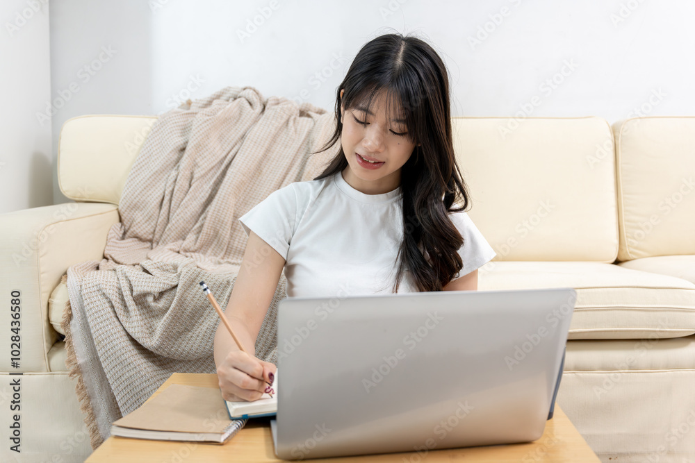 Asian woman having online meeting on laptop Asian woman having online meeting on laptop