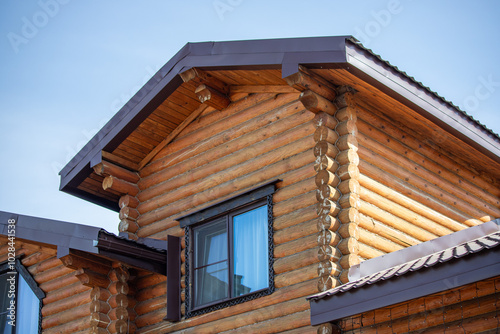 A wooden house with a slanted roof and a window