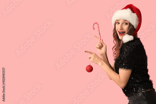 Young woman in Santa hat ho...