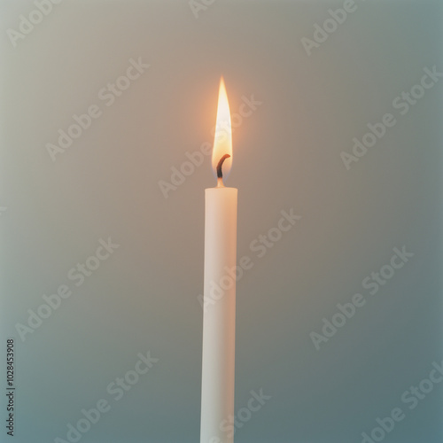 Single lit white candle with soft glow against a neutral background