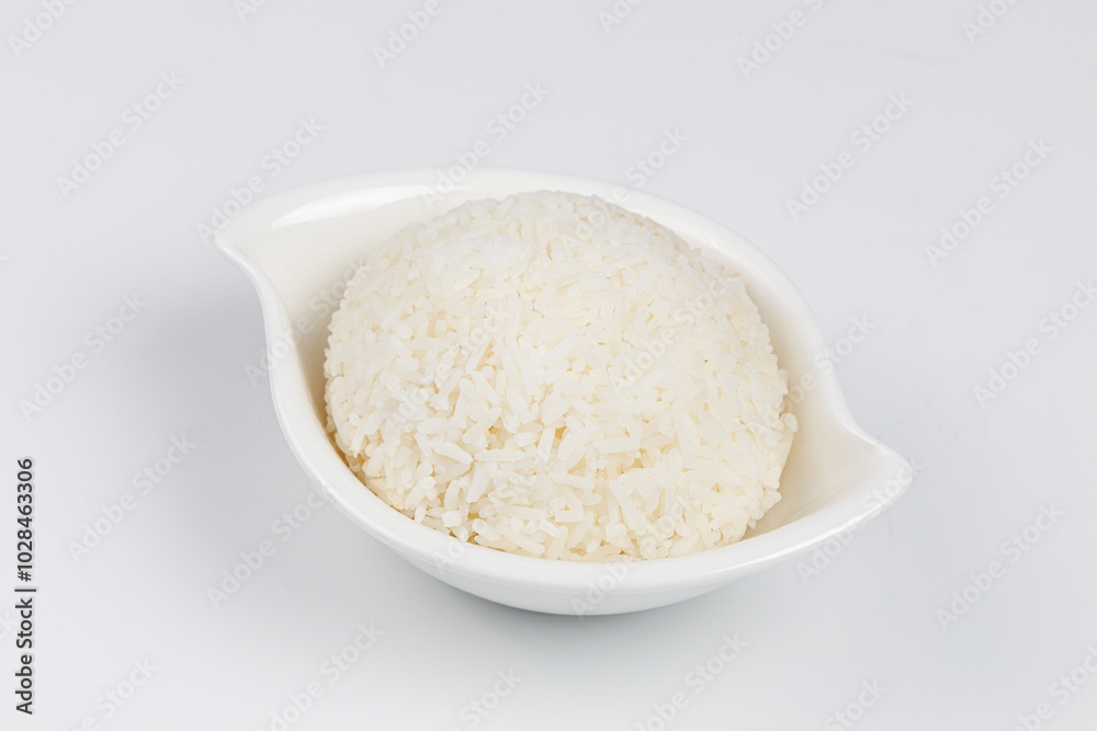 Rice in a white bowl on a white background Rice in a white bowl on a white background