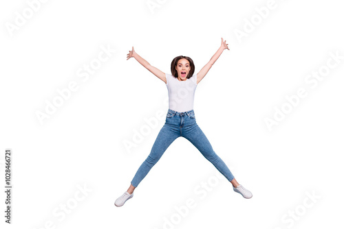 Full size photo of cheerful youth raising hands shouting wearing white t-shirt denim jeans isolated over blue background