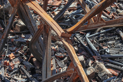 The ruins of the iron supporting the roof of the building which included broken roof tiles and wood left over from the building fire