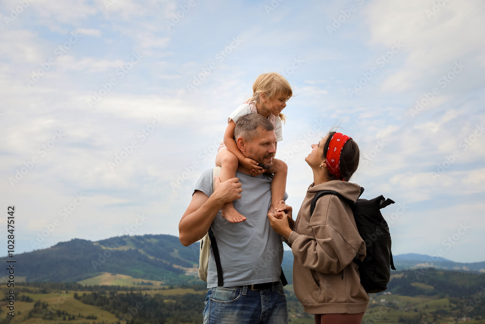 Family with backpacks travelling in mountains, space for text. Active tourism Family with backpacks travelling in mountains, space for text. Active tourism