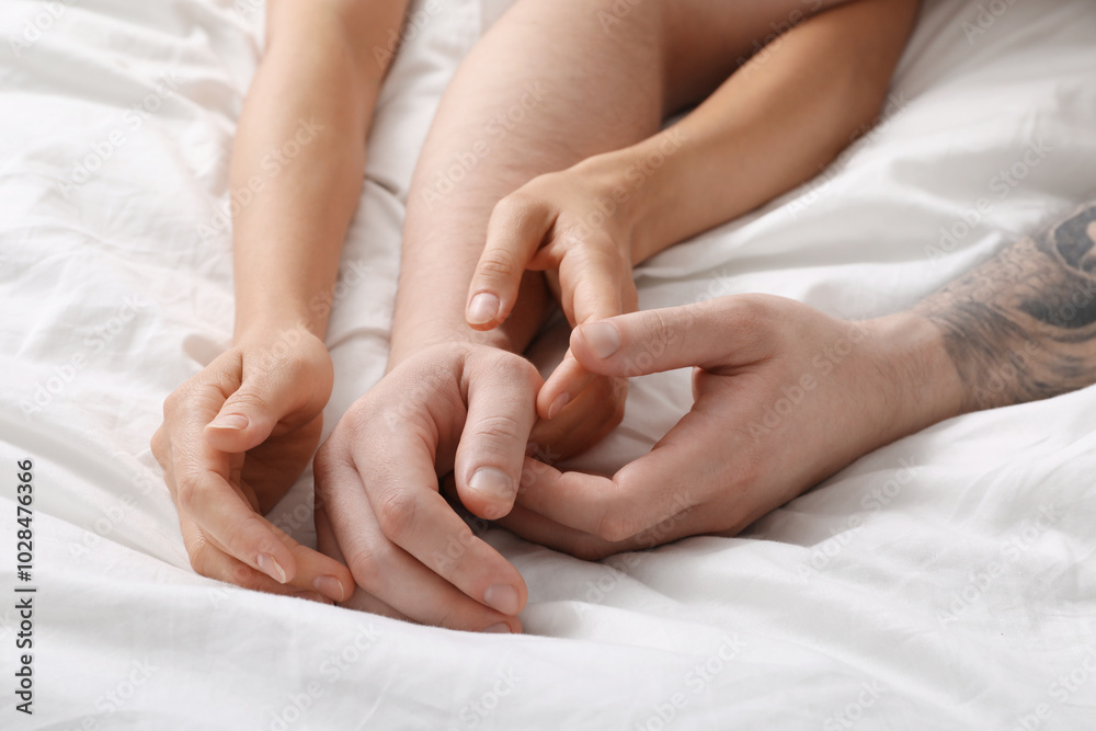 Lovely couple holding hands in bed, closeup Lovely couple holding hands in bed, closeup