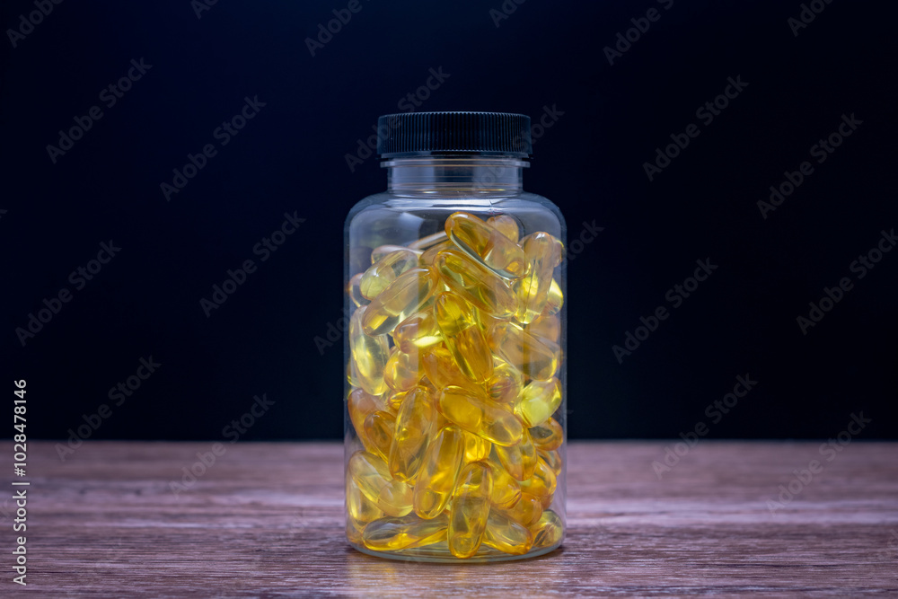 A bottle of fish oil pills sits on a wooden table A bottle of fish oil pills sits on a wooden table