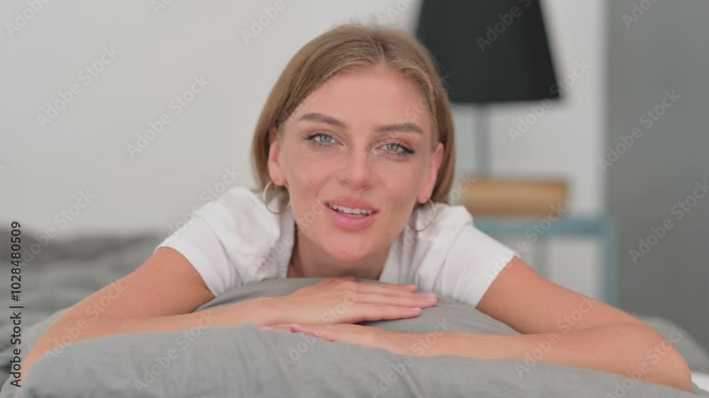Webcam View of Young Woman Doing Video Chat while Lying on Stomach in Bed Webcam View of Young Woman Doing Video Chat while Lying on Stomach in Bed