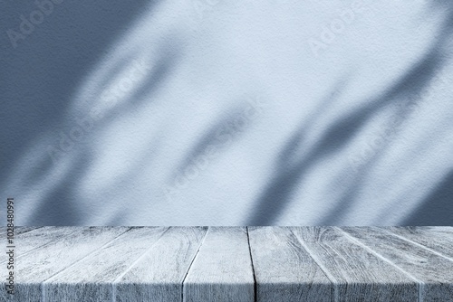 Wood Table with Light Beam and Leaves Shadow on Coastal Blue Wall, Suitable for Product Presentation Backdrop, Display, and Mock up.