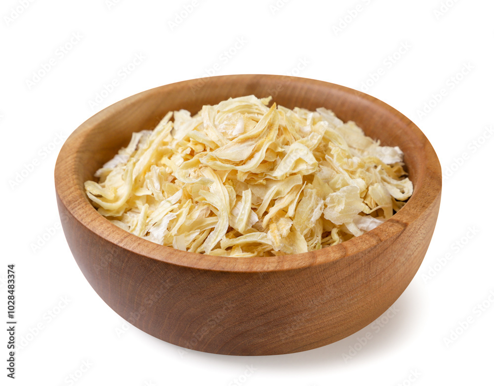 Dried onions in a wooden plate on a white background. Isolated Dried onions in a wooden plate on a white background. Isolated