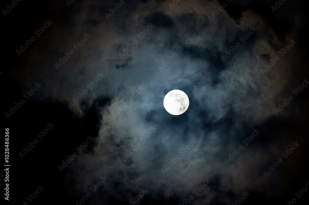 Halloween background. Night mysterious landscape in cold tones - Halloween night with full moon in the night sky and dramatic night clouds Halloween background. Night mysterious landscape in cold tones - Halloween night with full moon in the night sky and dramatic night clouds