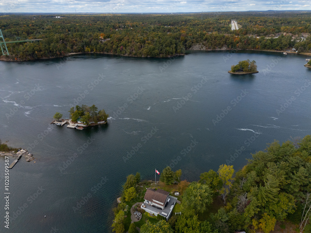 Fototapeta premium Tranquil aerial view of the 1000 Islands region, showcasing scattered islands on serene waters under a vast sky, capturing natural beauty and peacefulness.