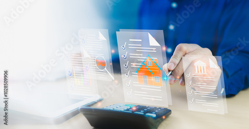 Homes and Residences Documents related to residential building loans through banks, including government tax refunds and tax deductions. Businessman using calculator and laptop