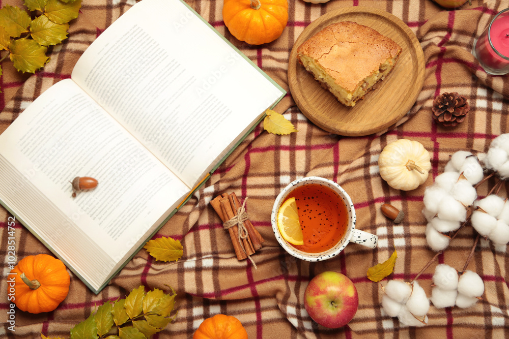 Hello autumn. Pumpkin, cup of tea, apple pie, autumn leaves, book on plaid. Happy Thanksgiving Hello autumn. Pumpkin, cup of tea, apple pie, autumn leaves, book on plaid. Happy Thanksgiving