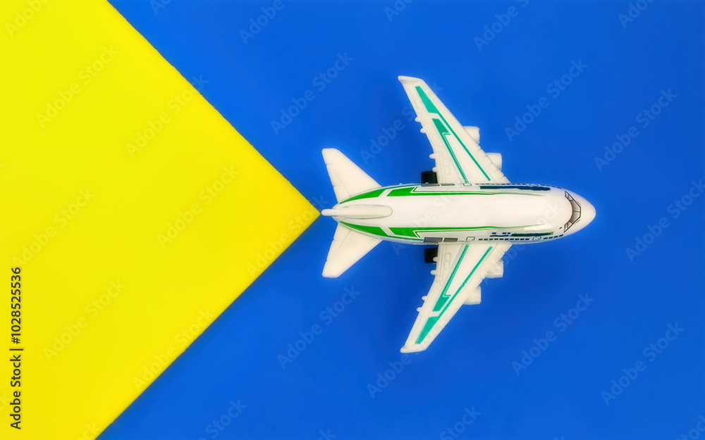 Toy airplane on blue and yellow background Toy airplane on blue and yellow background