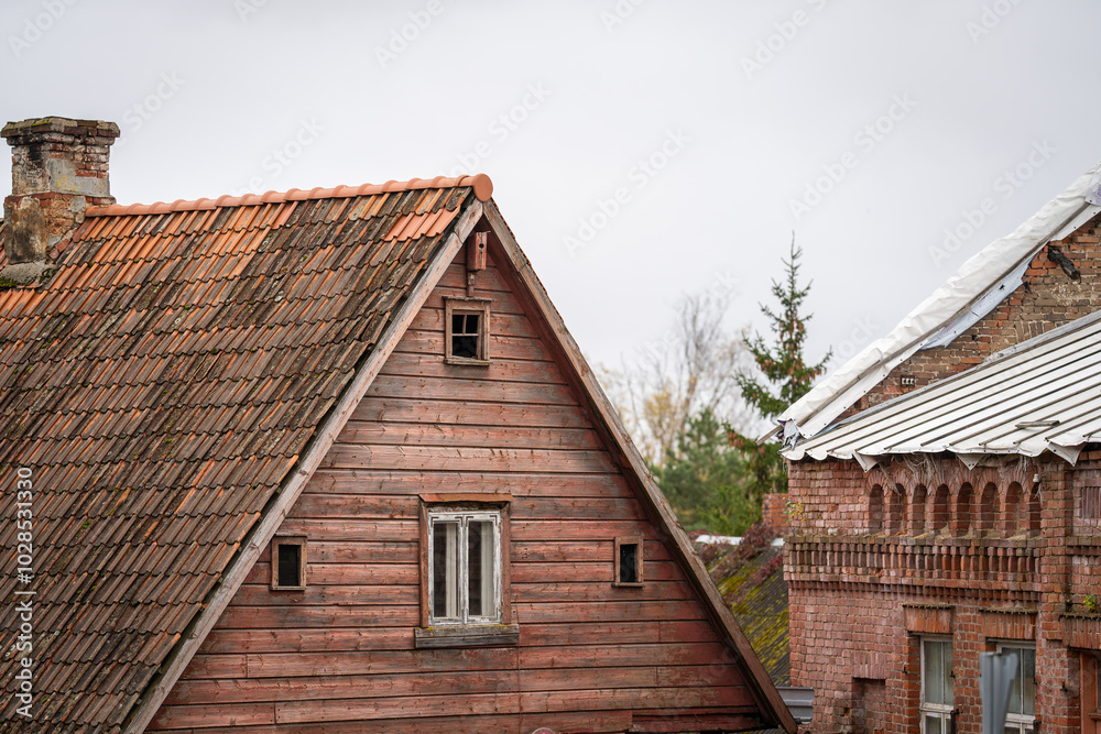 Buildings in need of renovation. Two houses showing signs of decay, a wooden residence and a brick building.
Buildings in need of renovation. Two houses showing signs of decay, a wooden residence and a brick building.