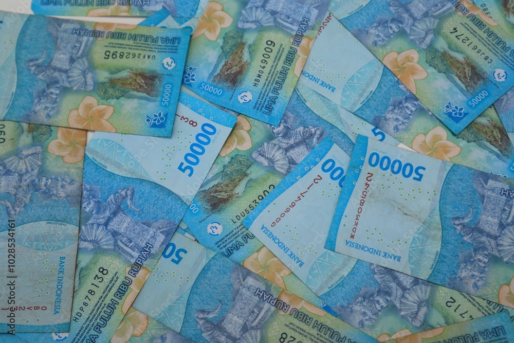 Background of a pile of banknotes with a value of Rp. 50000, with a close up view. Background of a pile of banknotes with a value of Rp. 50000, with a close up view.