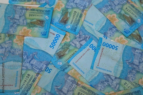 Background of a pile of banknotes with a value of Rp. 50000, with a close up view.