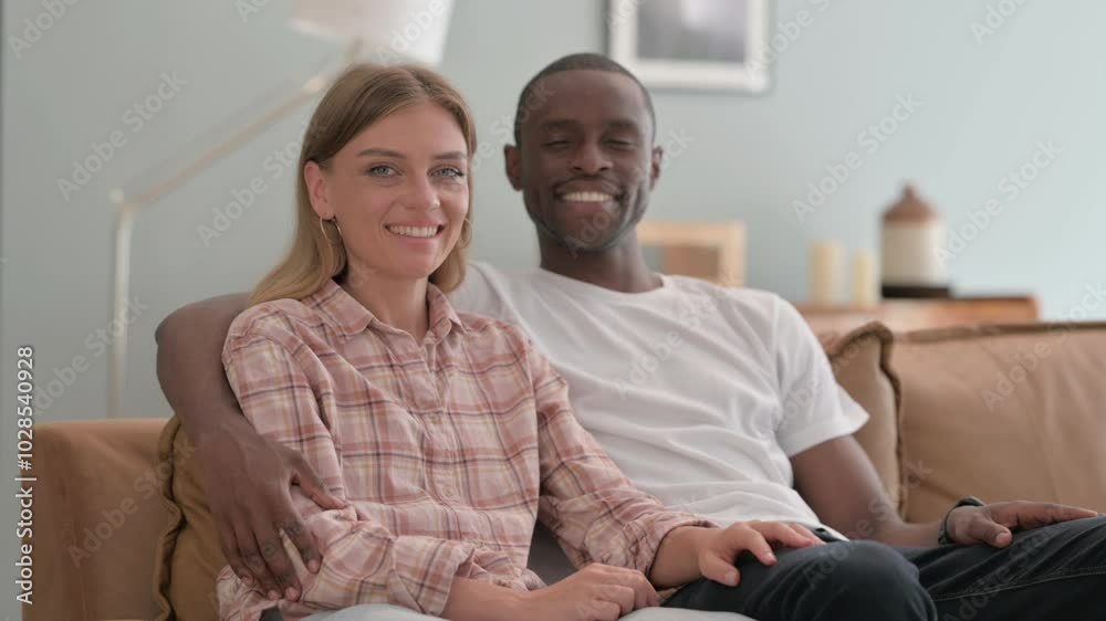 Smiling Interracial Couple Sitting at Home Smiling Interracial Couple Sitting at Home