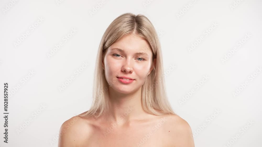 Young blonde woman posing at camera looking and smiling naturally, positive expression, isolated on white studio background. Beauty skin care concept Young blonde woman posing at camera looking and smiling naturally, positive expression, isolated on white studio background. Beauty skin care concept