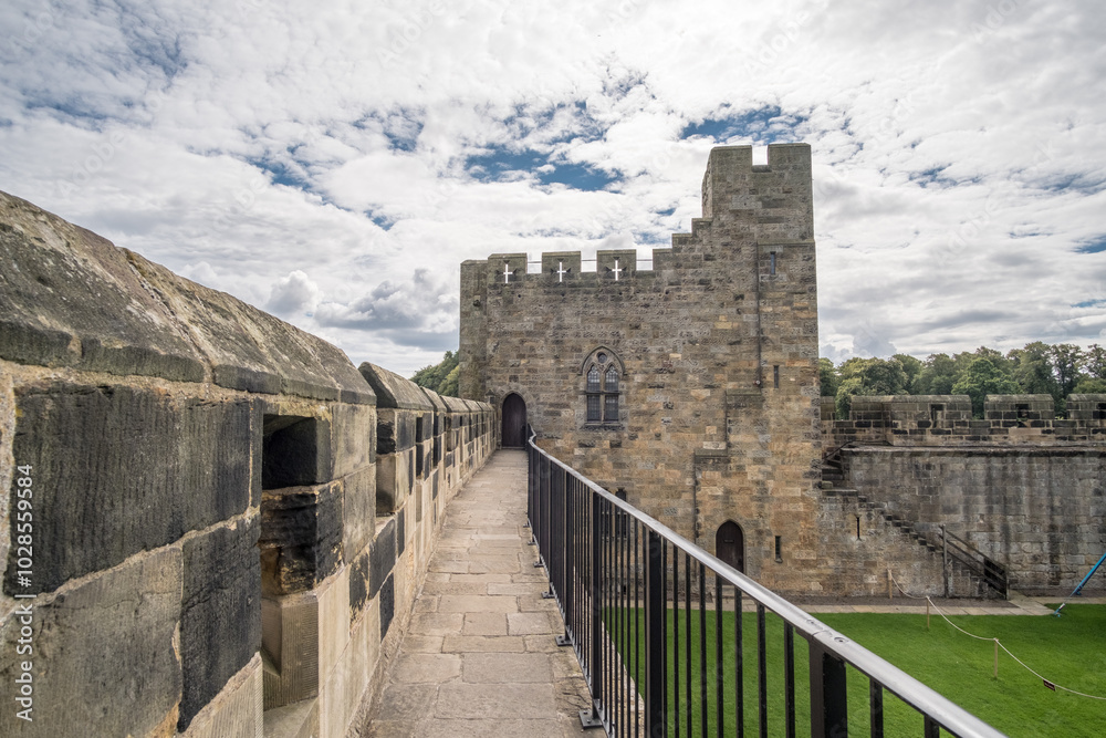 Fototapeta premium Alnwick, England - 5 August 2017: Alnwick Castle in Alnwick in the English county of Northumberland, United Kingdom. It is a location for films and programs.