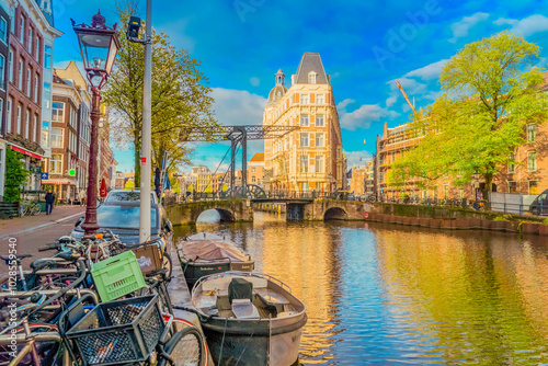 Facades of old historic Houses and trees over canal water, Amsterdam, Netherlands